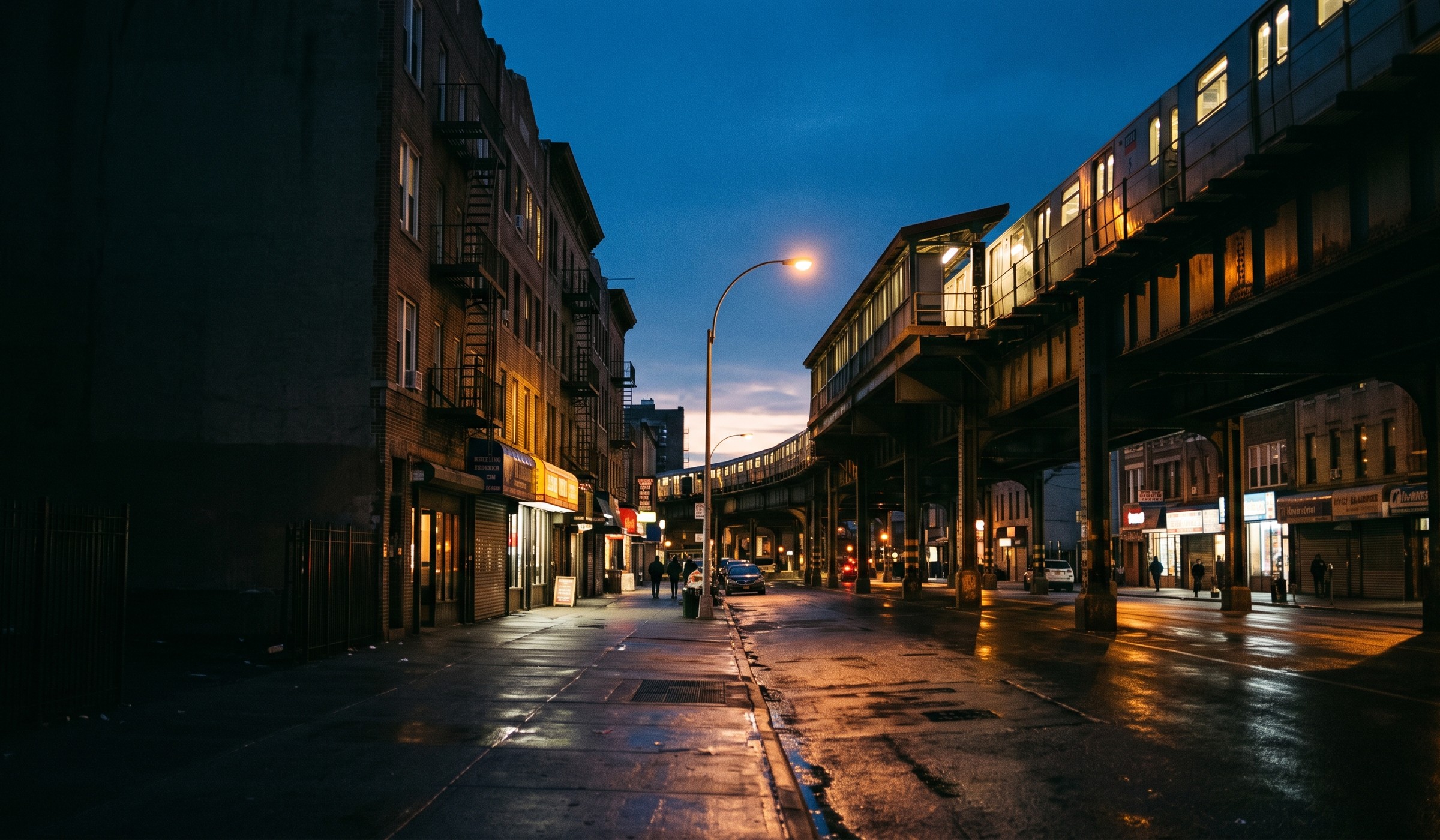 White Plains Road corridor in the Bronx at dusk, elevated tracks and neighborhood storefronts